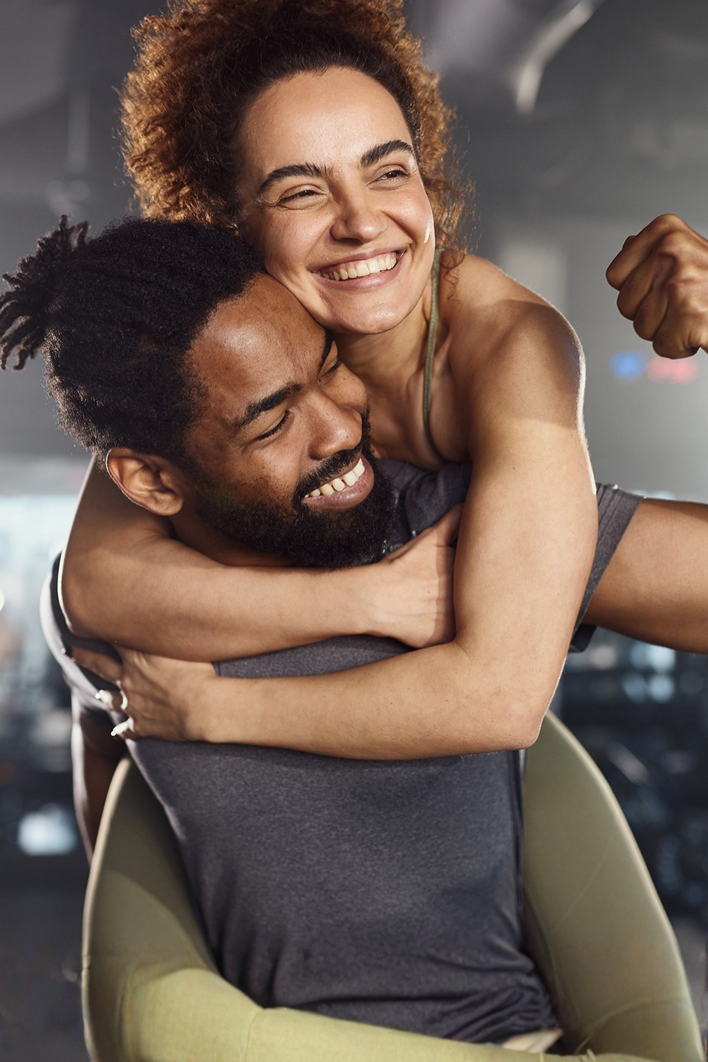 Two people embracing each other in a fitness atmosphere