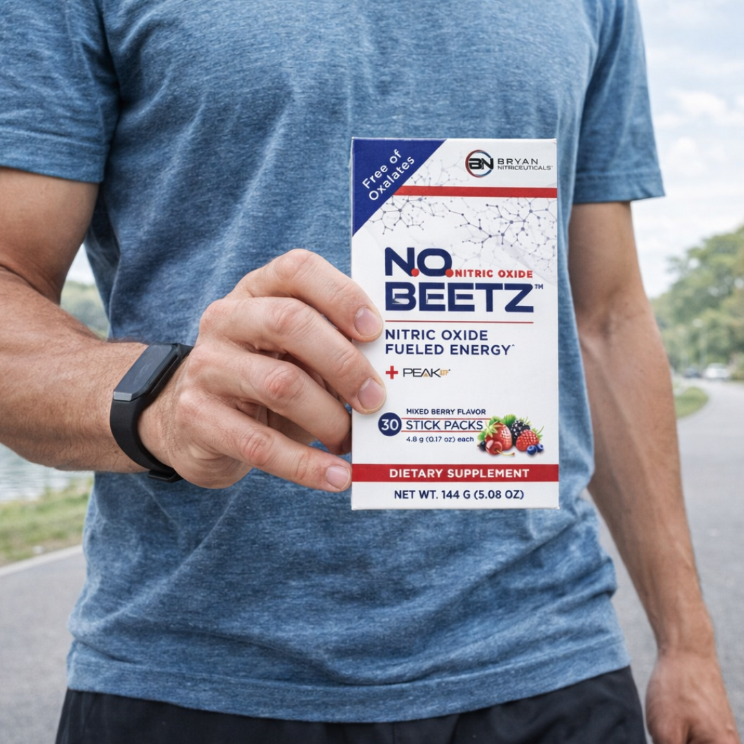 Person holding a package of NO BEETZ nitric oxide fueled energy supplement outdoors.