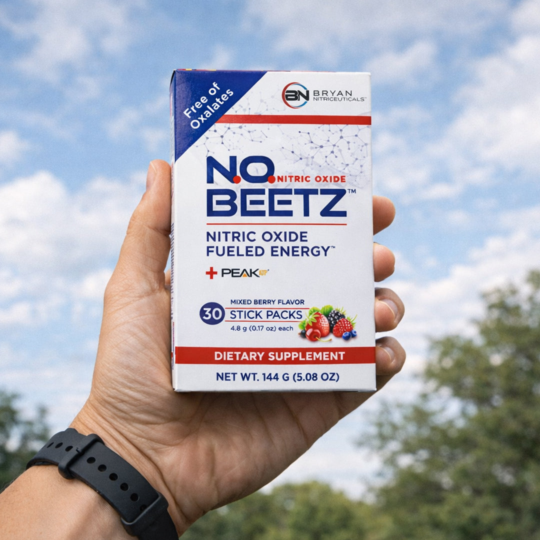Hand holding a box of NO BEETZ supplement with a blue sky and trees in the background