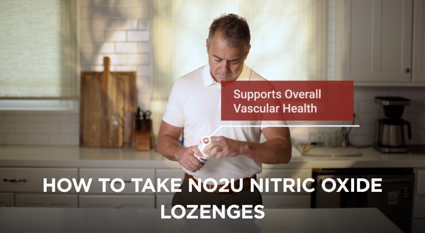Man in a kitchen holding NO2U nitric oxide lozenges with text about supporting vascular health.