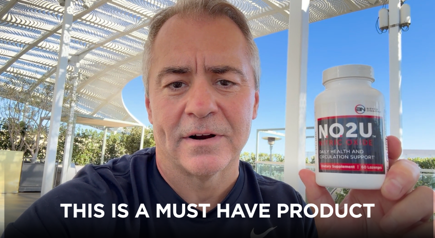 Man holding a supplement bottle labeled 'NO2U' with text 'THIS IS A MUST HAVE PRODUCT' outdoors.